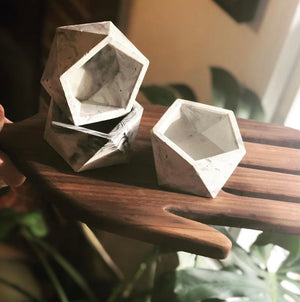 Three Helena planters, handmade by Queen City ‘Crete, sit on a tray.