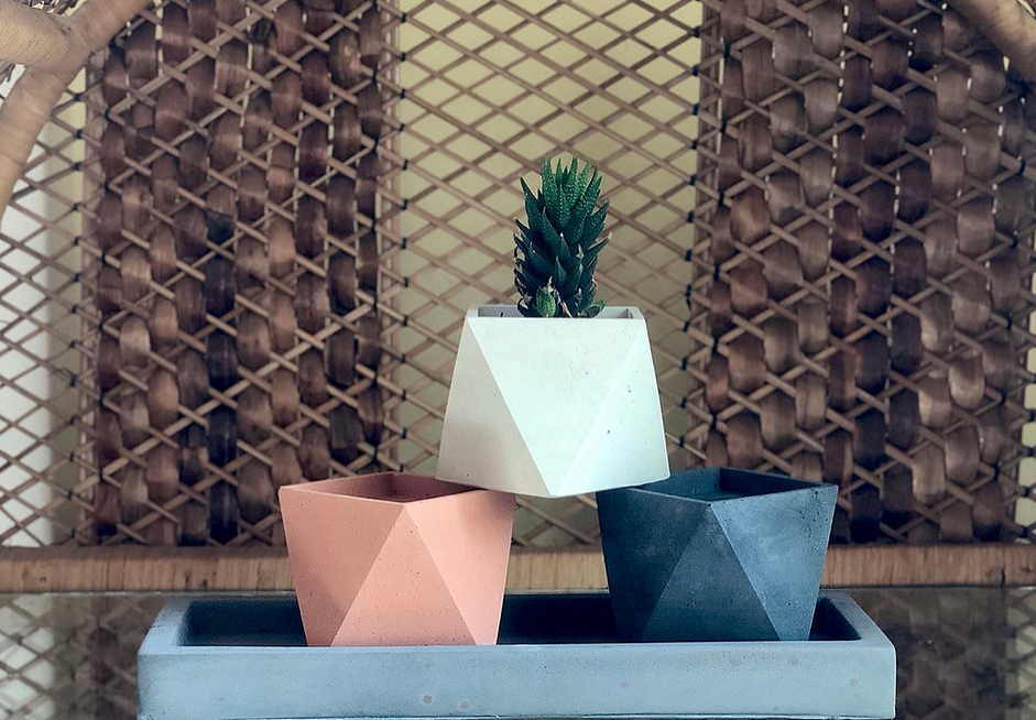 Three Amelia planters, all handmade by Queen City ‘Crete, sit stacked in a rectangular tray, also created by Queen City ‘Crete.