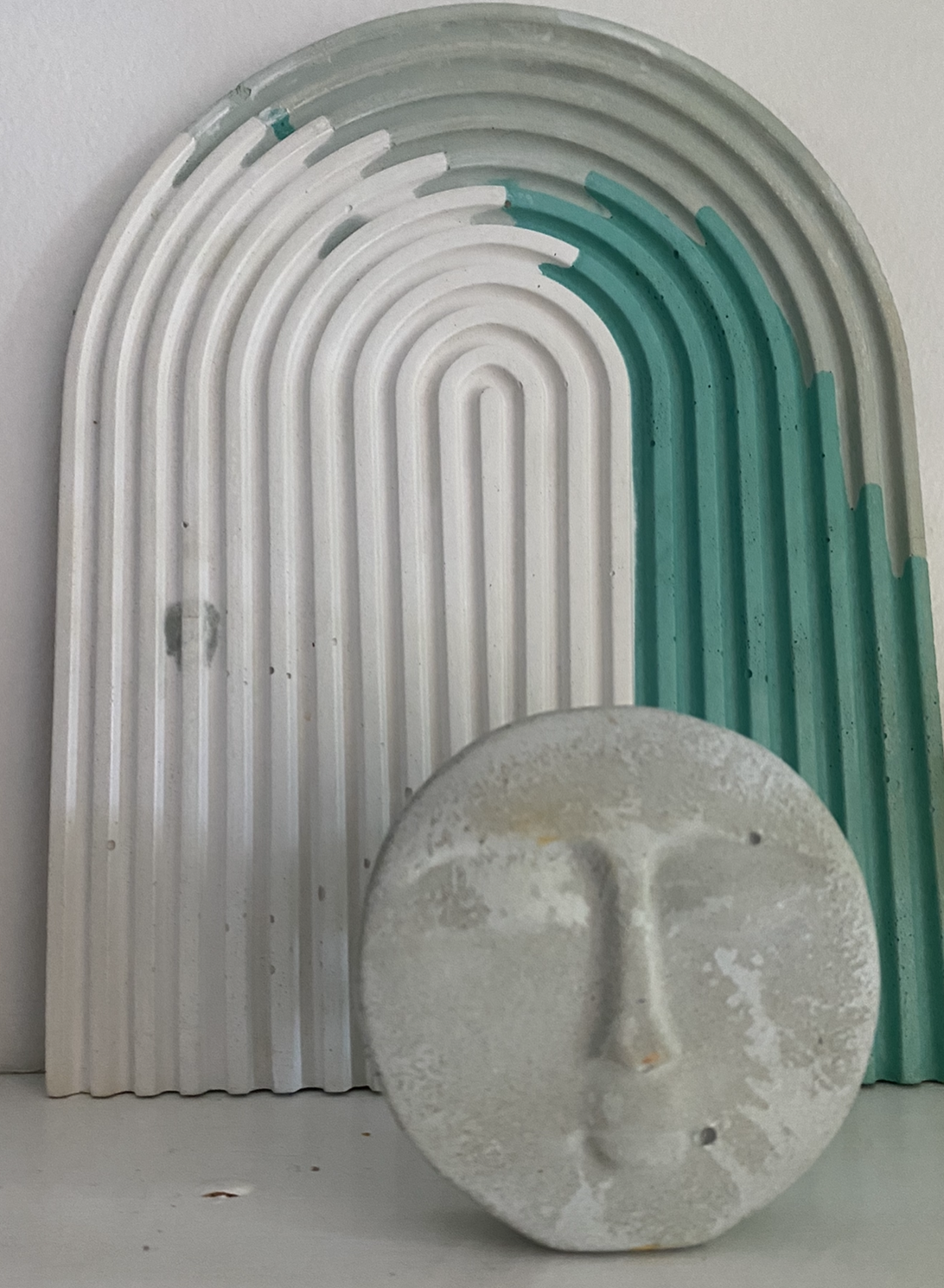 A concrete rainbow tray created by Queen City ‘Crete, sits behind a Luna Incense Holder, also from QCC.